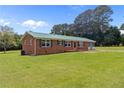 Attractive home with a green roof, complementing the surrounding greenery at 4001 Western Hills Dr, Sanford, NC 27330