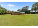 Inviting home with a well-maintained lawn and classic architectural details at 4001 Western Hills Dr, Sanford, NC 27330