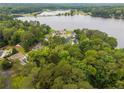 Aerial view of waterfront homes surrounded by lush trees and a beautiful lake at 968 S Bay Dr, Sanford, NC 27332