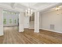 Bright, spacious living room with hardwood floors, tall windows, and a staircase at 116 Springside Dr, Spring Lake, NC 28390