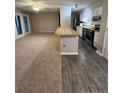 Open-concept kitchen and living area, showcasing modern appliances and a breakfast bar at 1321 Park Glen Dr # 202, Raleigh, NC 27610