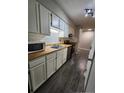 Well-lit kitchen featuring white cabinets, stainless steel appliances, and wood countertops at 1321 Park Glen Dr # 202, Raleigh, NC 27610