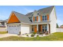 Inviting two-story home with a well-manicured lawn and an attached two-car garage at 152 Century Dr, Cameron, NC 28326