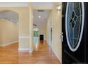 Inviting foyer with wood floors, soft yellow walls, and archway to the living area at 3245 Bristol St, Sanford, NC 27332