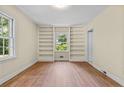 Bright bedroom featuring hardwood floors, built-in shelving and abundant natural light at 511 Maplewood Dr, Sanford, NC 27330