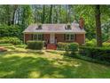 Traditional brick home with black shutters, dormer windows and well-maintained landscaping at 511 Maplewood Dr, Sanford, NC 27330