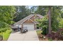 Charming two-story home with manicured lawn, two-car garage, and boat parked in the driveway at 69 Night Heron Ct, Sanford, NC 27332