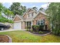 Charming two-story home with stone accents, manicured lawn, and a two-car garage at 69 Night Heron Ct, Sanford, NC 27332