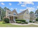 Inviting two-story home with stone accents, a covered porch, and a two-car garage at 716 Micahs N Way, Spring Lake, NC 28390
