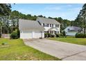 Charming two-story home with a well-manicured front lawn and a two-car garage at 717 Stone Cross Dr, Spring Lake, NC 28390