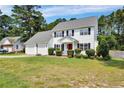 Charming two-story home with a well-manicured front lawn and a two-car garage at 717 Stone Cross Dr, Spring Lake, NC 28390
