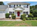 Charming two-story home with a brick front entrance and well-manicured landscaping at 717 Stone Cross Dr, Spring Lake, NC 28390