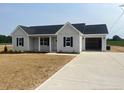 Attractive single-story home with an attached two-car garage and a well-maintained lawn at 1036 Turlington Rd, Dunn, NC 28334