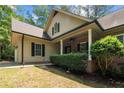 Attractive home showcasing the covered porch, brick accents, and manicured lawn at 3046 Creek Run, Sanford, NC 27332