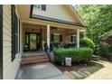 Inviting front porch with brick steps, black railings, and a cozy seating area at 3046 Creek Run, Sanford, NC 27332