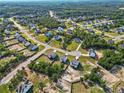 An aerial view captures a neighborhood with tree-lined streets and manicured lawns at 334 Bunting Dr, Lillington, NC 27546