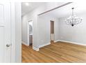 Open living area with wood floors, neutral walls, decorative lighting, and an ensuite bath view at 7057 Oak Rd, Sanford, NC 27332