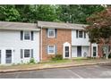 Charming townhome featuring brick facade and well-manicured front yard landscaping at 1255 Donaldson Ct, Cary, NC 27511