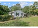 Well-maintained single-story home with a fenced yard and green lawn, surrounded by mature trees at 177 Gladiola Dr, Spring Lake, NC 28390