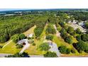 Aerial view of a homesite including two homes, with 5.4 acres, landscaping, and trees at 222 St. Andrews Church Rd, Sanford, NC 27332