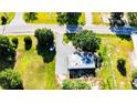 Aerial view of the property showing a building with parking, trees, and a grassy area at 222 St. Andrews Church Rd, Sanford, NC 27332