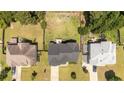 Aerial view of a home with a spacious backyard, surrounded by lush greenery and neighboring houses at 364 Heathrow Dr, Spring Lake, NC 28390
