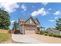 Exterior view of the home showcasing the driveway, landscaping, and two-car garage at 416 Kentucky Derby Ln, Lillington, NC 27546