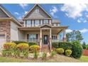 Inviting front exterior featuring a covered porch and well-maintained landscaping at 416 Kentucky Derby Ln, Lillington, NC 27546