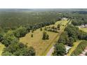 A large plot of land with tilled soil and scattered trees, seen from an aerial perspective at 472 Walter Bright Rd, Sanford, NC 27330