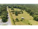 An aerial view shows fields, trees, and a road, highlighting the property's location and landscape at 472 Walter Bright Rd, Sanford, NC 27330