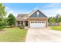 Charming home with stone accents, complemented by lush greenery and a well-kept lawn at 95 Taft Ln, Cameron, NC 28326