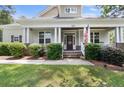 Inviting front porch with classic columns and an American flag displayed at 951 Whispering Pines Dr, Spring Lake, NC 28390