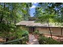 The exterior of this home is nestled amongst trees, featuring a stone and brick walking path at 1363 Maryland Ct, Sanford, NC 27332