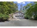 Spacious garage with ample parking and driveway, nestled among lush greenery at 1363 Maryland Ct, Sanford, NC 27332
