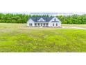 Expansive aerial view of a charming white farmhouse-style home with a large lawn at 193 Jim S Rd, Cameron, NC 28326