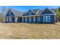 Spacious blue home featuring a welcoming front porch and well-manicured lawn at 193 Jim S Rd, Cameron, NC 28326