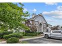 Well-maintained apartment building featuring stone accents, mature trees, and convenient parking spaces at 291 Gallery Dr # 104, Spring Lake, NC 28390