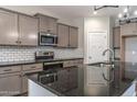 Modern kitchen featuring stainless steel appliances, stylish countertops, and ample cabinet space for storage at 355 Shaw Rd, Cameron, NC 28326