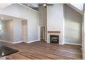 Inviting living room featuring a fireplace, high ceilings, and hardwood floors, creating a cozy atmosphere at 355 Shaw Rd, Cameron, NC 28326
