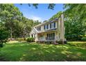 Well-maintained home featuring a charming front porch, manicured lawn, and mature trees at 609 Fairway Dr, Sanford, NC 27330
