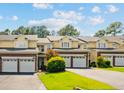 Attractive townhome showcasing a brick facade, attached garages, and neatly maintained landscaping at 82 Pine Hawk Dr, Spring Lake, NC 28390