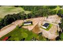 Expansive aerial view of two houses on a large lot surrounded by green fields and trees at 3987 Swanns Station Rd, Sanford, NC 27332