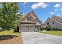 Beautiful two-story home featuring a two-car garage, complemented by a lush, green lawn at 50 Turner Mathews Ct, Spring Lake, NC 28390