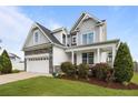 Charming home featuring a blend of stone, gray siding, and a perfectly landscaped yard at 81 Dot Ct, Fuquay Varina, NC 27526
