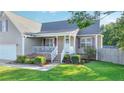 Beautiful single Gathering home with manicured lawn and charming front porch perfect for relaxing at 109 Shelby St, Spring Lake, NC 28390