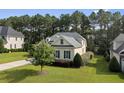 Beautiful home boasts lush green lawn and trimmed shrubbery surrounding the property at 259 Rolling Pines Dr, Spring Lake, NC 28390