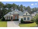 Charming two-story house with brick accents, dormers, and a well-manicured lawn at 259 Rolling Pines Dr, Spring Lake, NC 28390