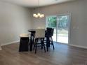 Dining room featuring modern table and chairs, and a sliding glass door to the backyard at 286 Beacon Hill Rd, Lillington, NC 27546
