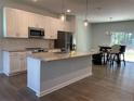 Modern kitchen with stainless steel appliances, granite countertops, and a center island at 286 Beacon Hill Rd, Lillington, NC 27546