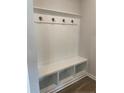 Convenient mudroom with built-in bench, storage cubbies, and hooks for organization at 286 Beacon Hill Rd, Lillington, NC 27546
